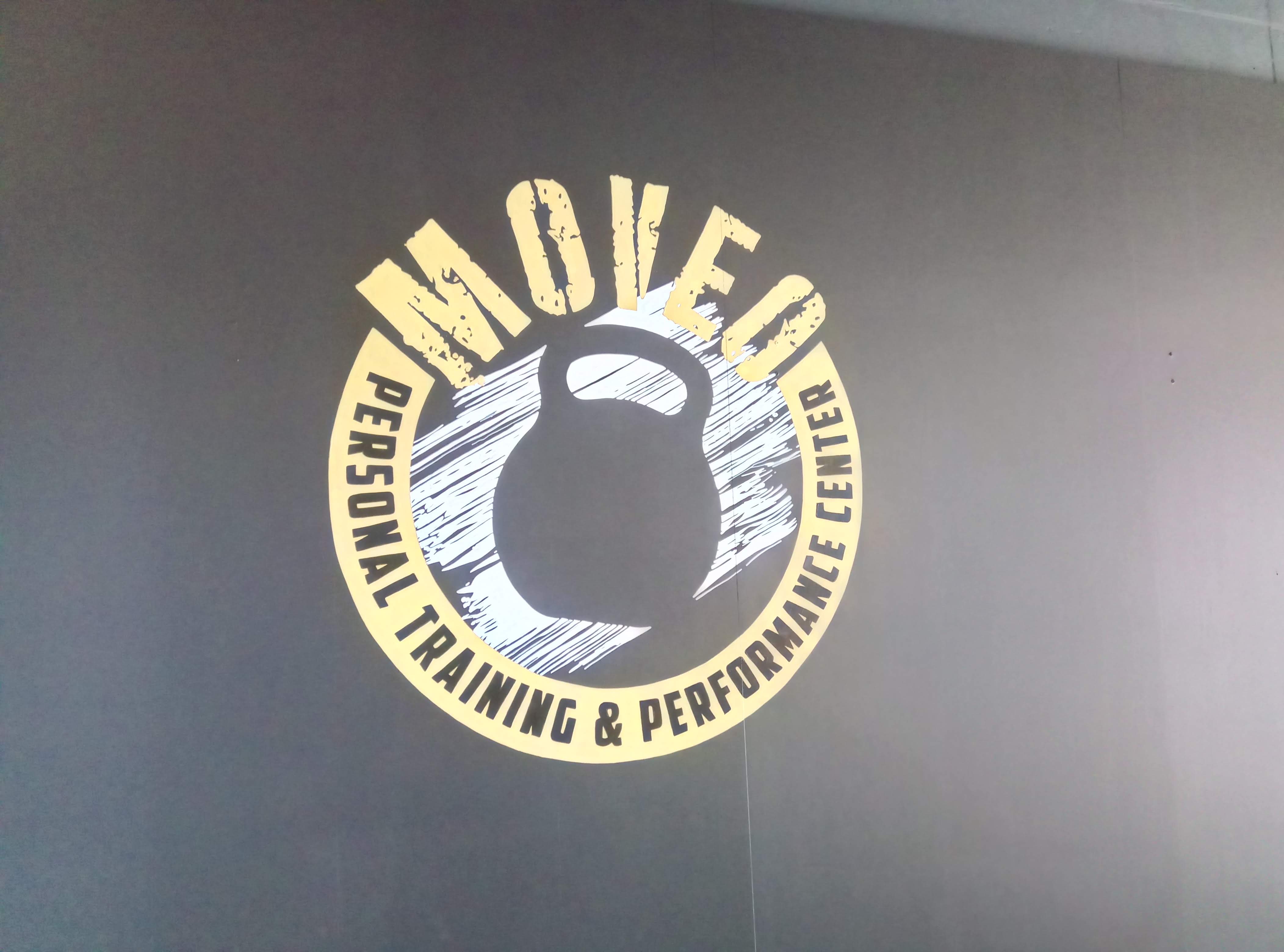 muurschildering van het logo van Moveo in een sportruimte
